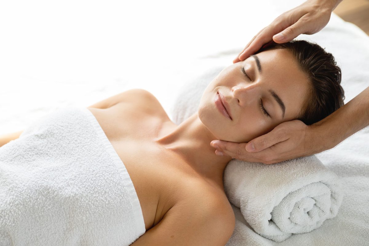 Young and beautiful woman is relaxing during facial massage session