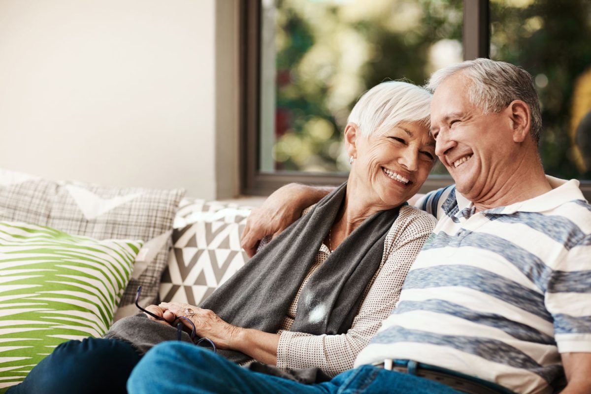 Shot of a happy senior couple relaxing together on a sofa outside at home