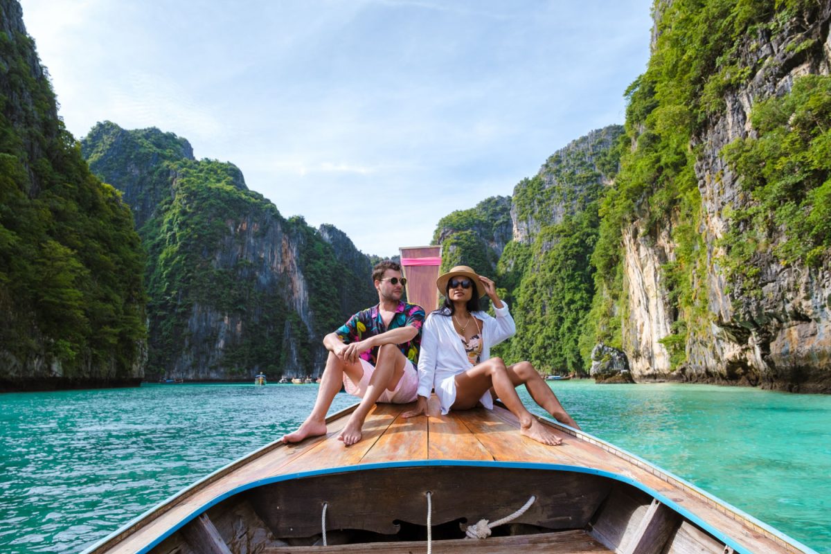 Couple men and women in Longtail boat at the lagoon of Koh Phi Phi Thailand. Pileh Lagoon Thailand Koh Phi Phi